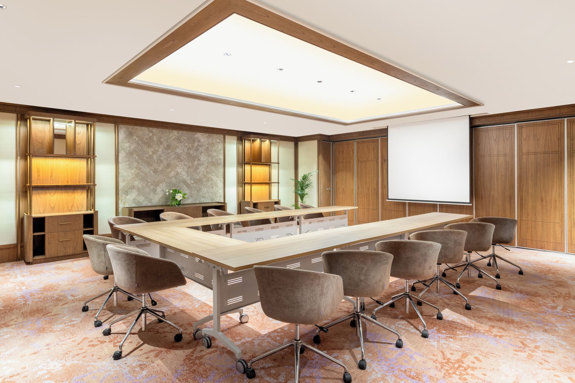 A conference room with a long table, multiple chairs, a whiteboard, and a large window.