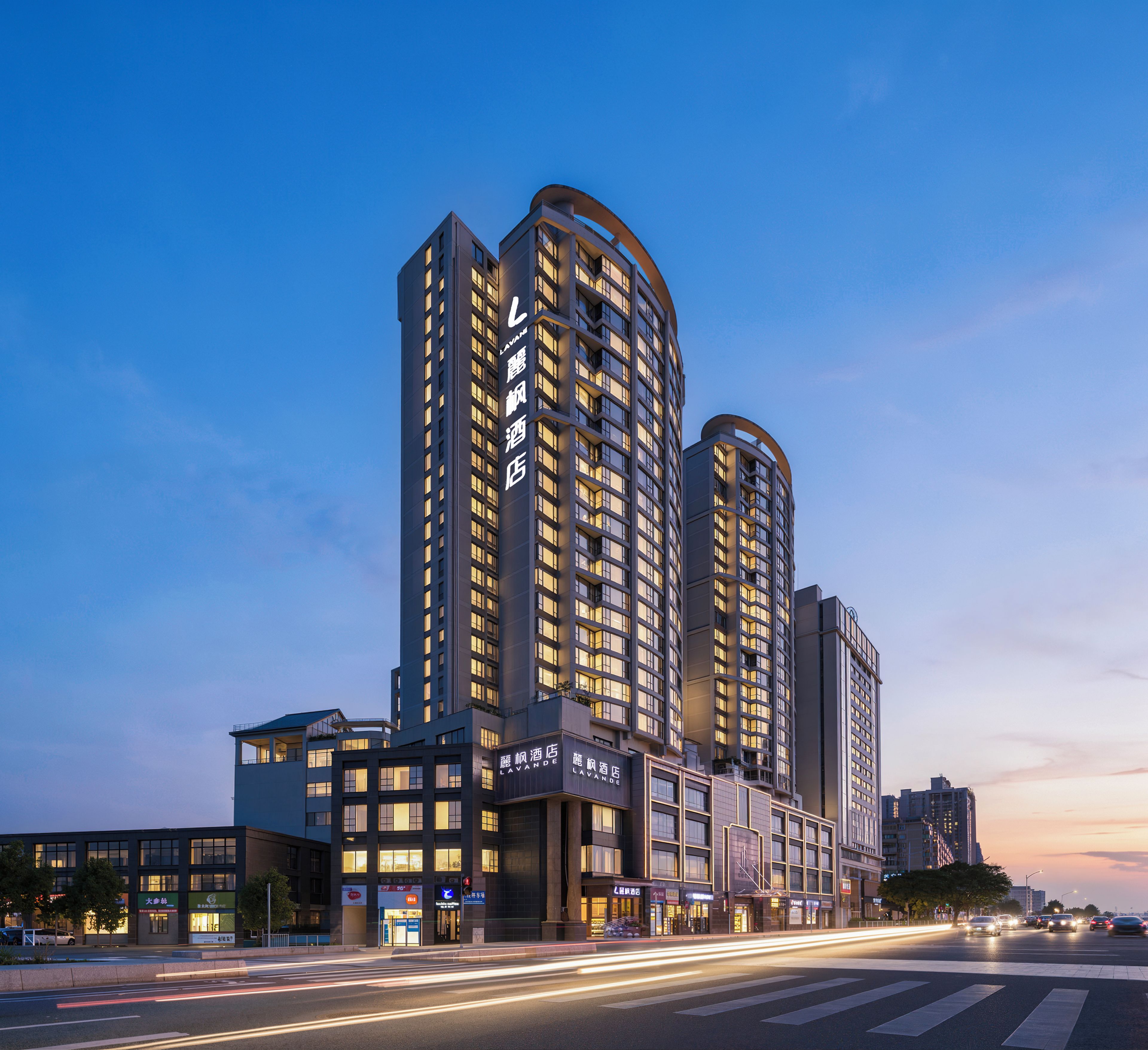 A multi-story hotel with a prominent entrance and signage.