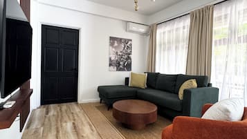 Condo de lujo, 2 habitaciones | Área de sala de estar | Smart TV de 65 pulgadas con canales digitales y Netflix