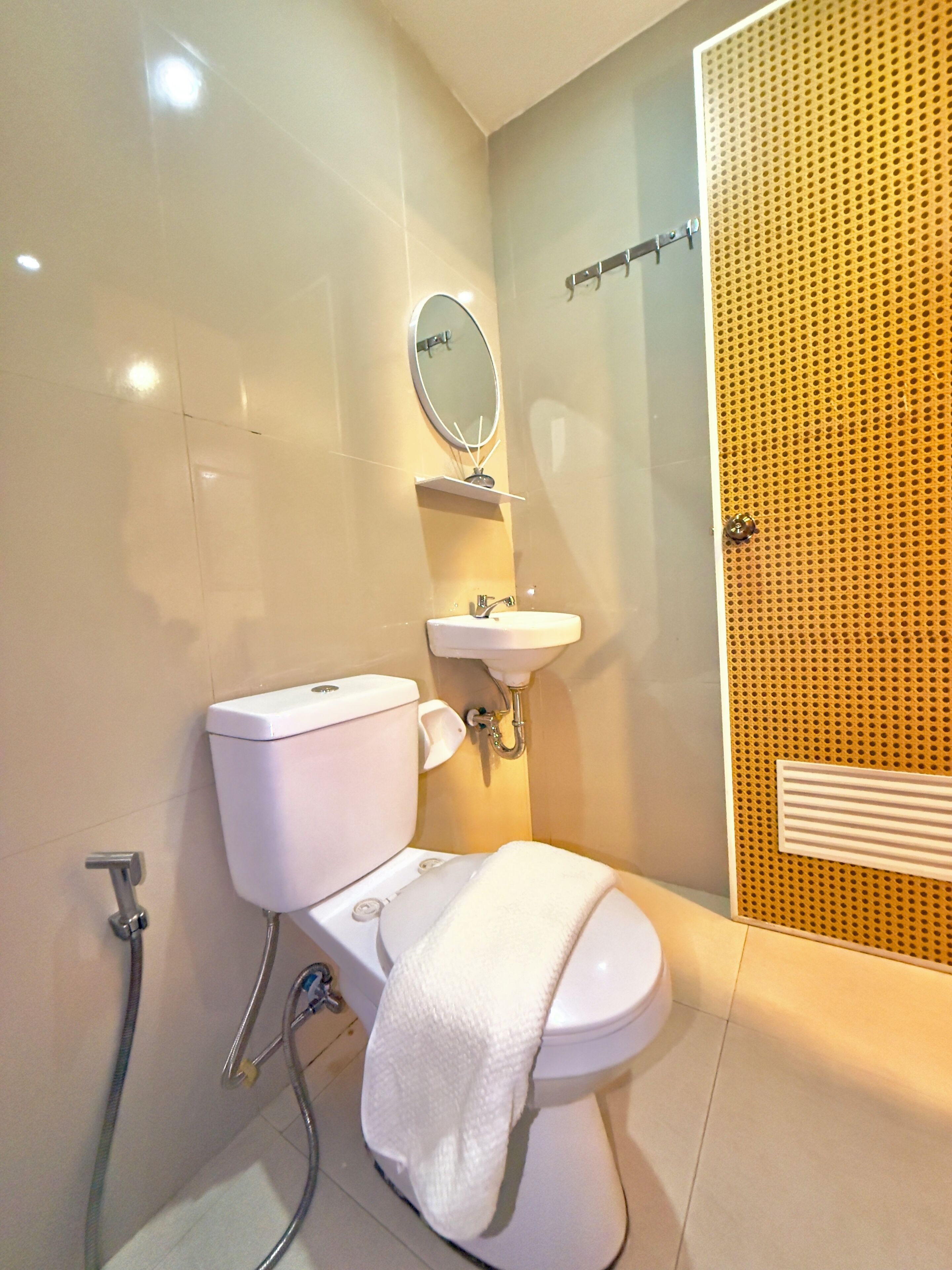 A modern bathroom with a toilet, sink, and shower.