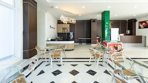 A modern hotel lobby with a coffee bar, seating area, and a reception desk. - Happy Home Boutique Hotel Vung Tau (Ho Chi Minh City)