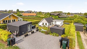 A residential area with modern houses, a gravel driveway, and well-maintained gardens. - "Arnia" - 250m from the sea by Interhome (Hejls)