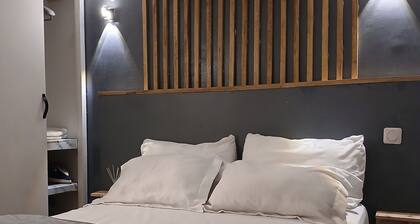 Warm, modern studio with designer staircase.