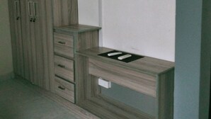 A room with a wooden wardrobe, a built-in desk with a flat surface, and a tiled floor. - Charming 2BR duplex house rooftop Oasis (Colombo)
