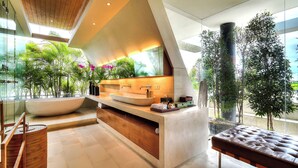 A modern bathroom with a large sink, wooden vanity, and a bench. - The Iman Villa by Elite Havens (Kabupaten Badung)
