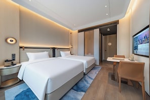 A modern hotel room with a large bed, bedside tables, a desk, and a television. - Grand Skylight International Hotel, Shenzhen Dapeng (Shenzhen)