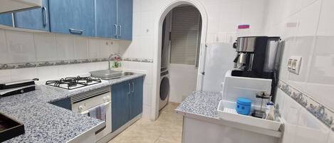 Fridge, microwave, coffee/tea maker, cookware/dishes/utensils