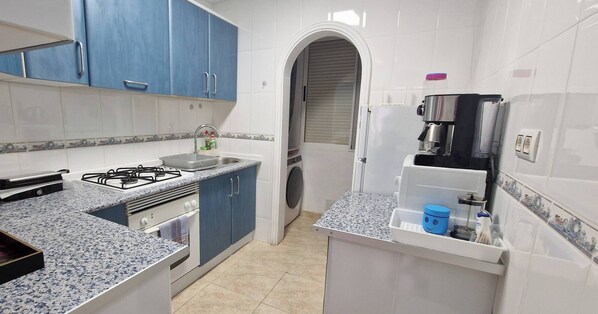 Fridge, microwave, coffee/tea maker, cookware/dishes/utensils