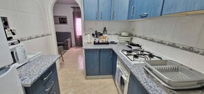 Fridge, microwave, coffee/tea maker, cookware/dishes/utensils