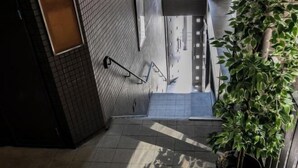 A staircase leading to a room with a view of a cityscape. - F・CROSS・EBISU (Osaka)