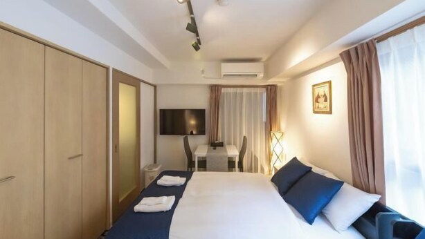 A hotel room with a bed, a desk, and a chair. - F・CROSS・EBISU (Osaka)