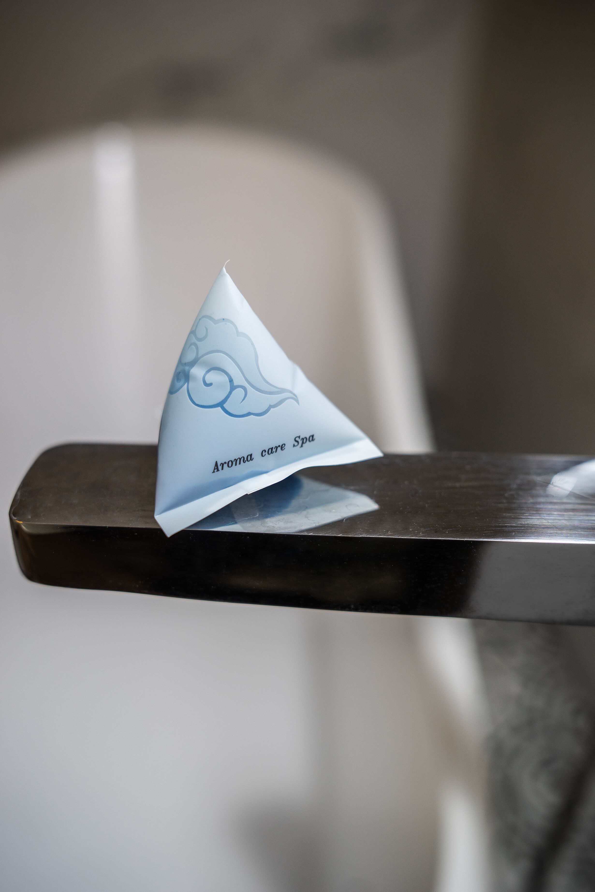 A triangular object with text on it, placed on a metallic surface.
