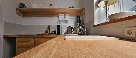 Fridge, stovetop, dishwasher, coffee/tea maker