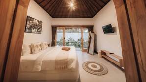 A bedroom with a large bed, wooden ceiling, and a view of a garden. - Hiraya Uluwatu (Pecatu)