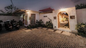 A modern building with a tiled entrance, a nameplate reading "HIRAYA", and a pathway leading to a covered entrance. - Hiraya Uluwatu (Pecatu)