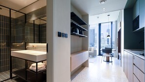 A modern bathroom with a large mirror, a vanity with a sink, and a shower area. There are shelves above the vanity and a view of the city through large windows. - Modern Studio Burj Khalifa View Upside Living (Dubai)