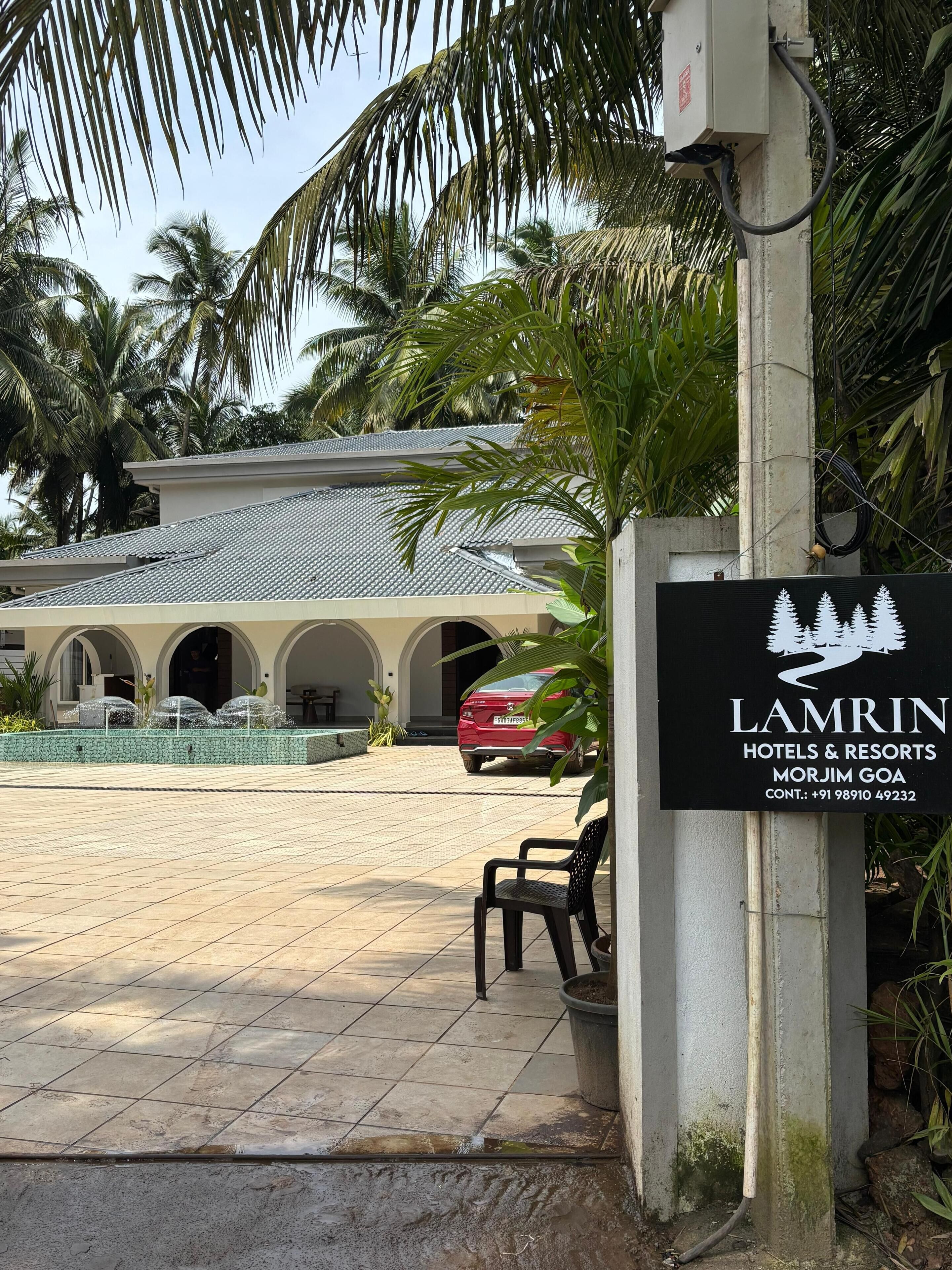 A hotel entrance with a sign for 'LAMRIN HOTELS & RESORTS MORJIM GOA'.