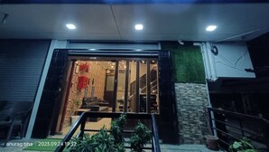 The entrance of Hotel Raas Inn with a modern design, featuring a glass door and a visible interior with seating and decor. - Hotel Raas Inn (Udaipur)