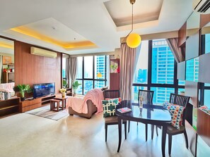 Apartment, 2 Bedrooms, City View | Living area | 55-inch Smart TV with cable channels