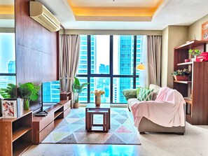 Apartment, 2 Bedrooms, City View | Living area | 55-inch Smart TV with cable channels