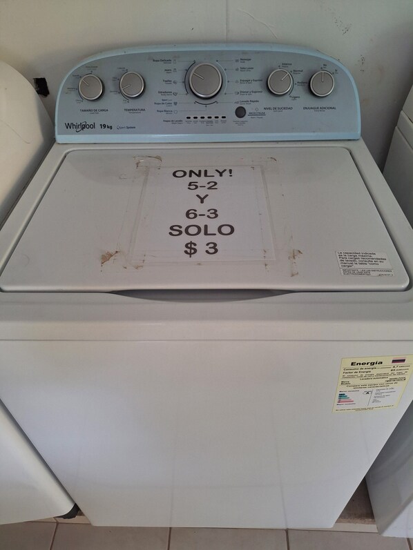 A Whirlpool 19 kg washer with a control panel and a sign on the door indicating it is for 5-2 and 6-3 loads only, priced at $3.