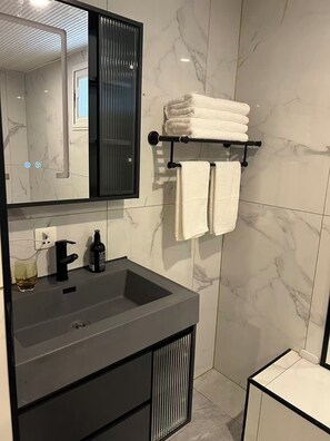 Shower, hair dryer, towels, soap