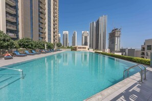Pool - Free housekeeping visits during your stay - StayShort - 2BR Apartment with Water Views in Dubai Creek Harbour (Dubai Creek Harbour)