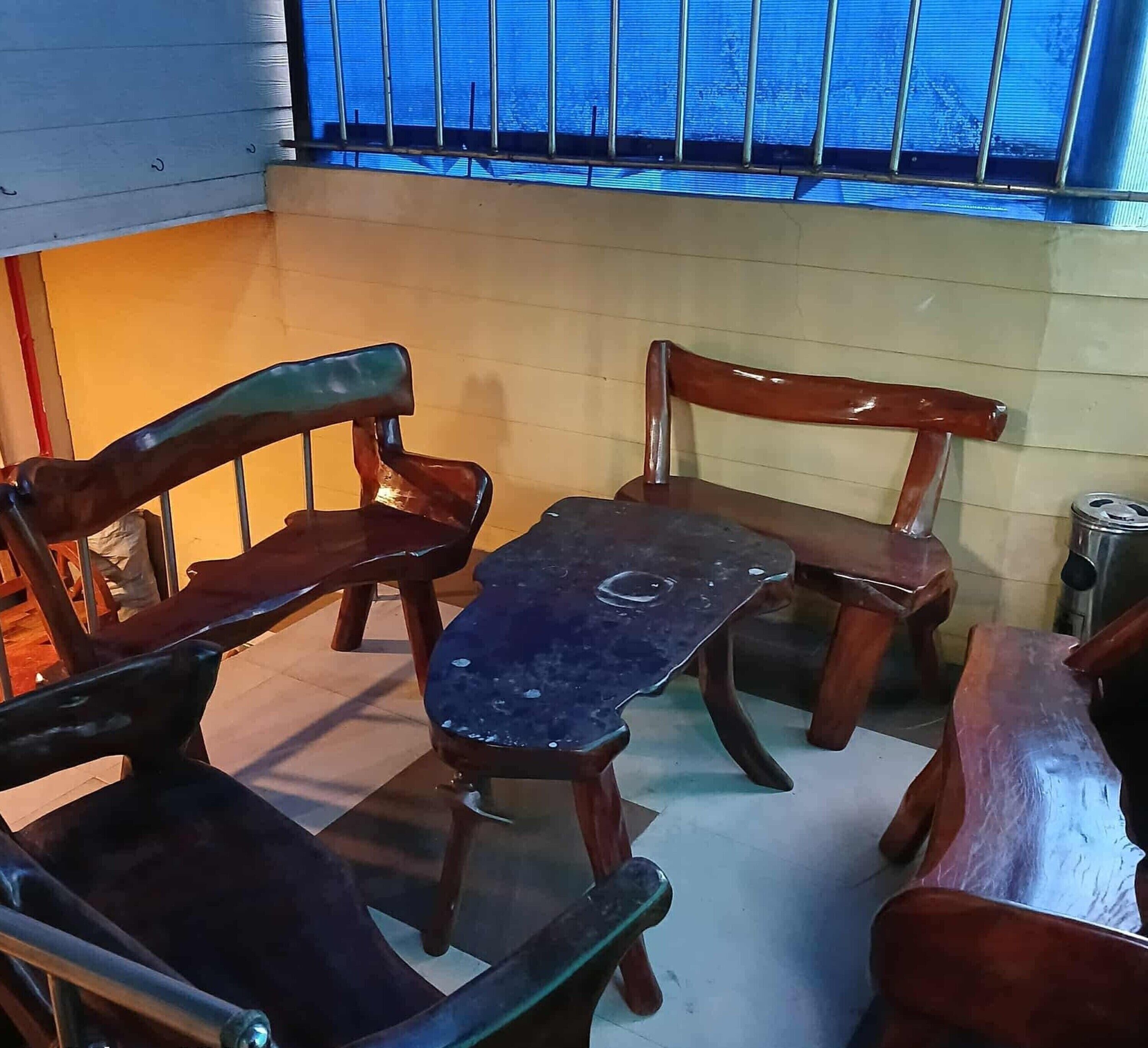 A small dining area with a table and four wooden chairs.