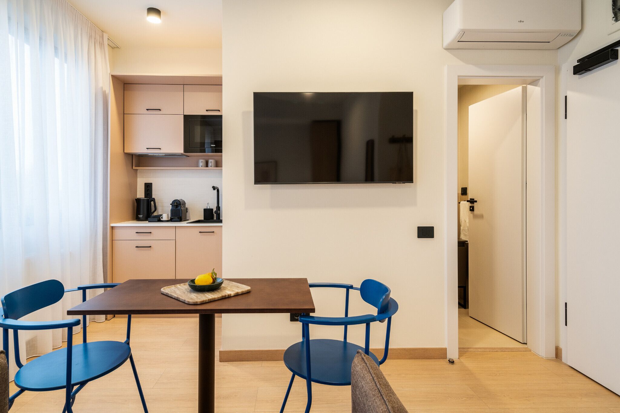A modern kitchen with a dining area.