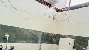 A bathroom with a toilet, sink, and shower. -  Connecting you with the Heritage & History of Udaipur. (Udaipur)