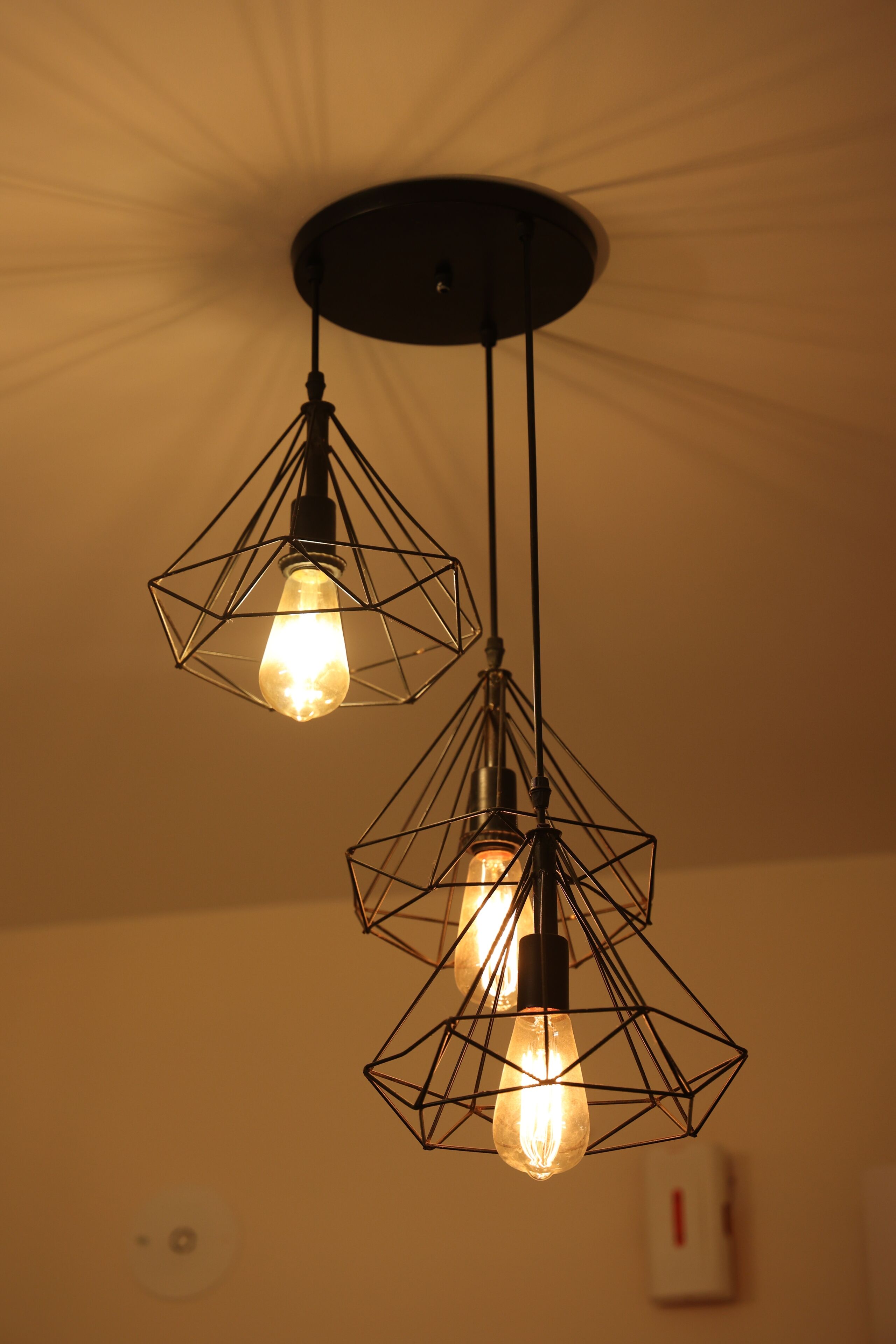 A ceiling with geometric light fixtures.