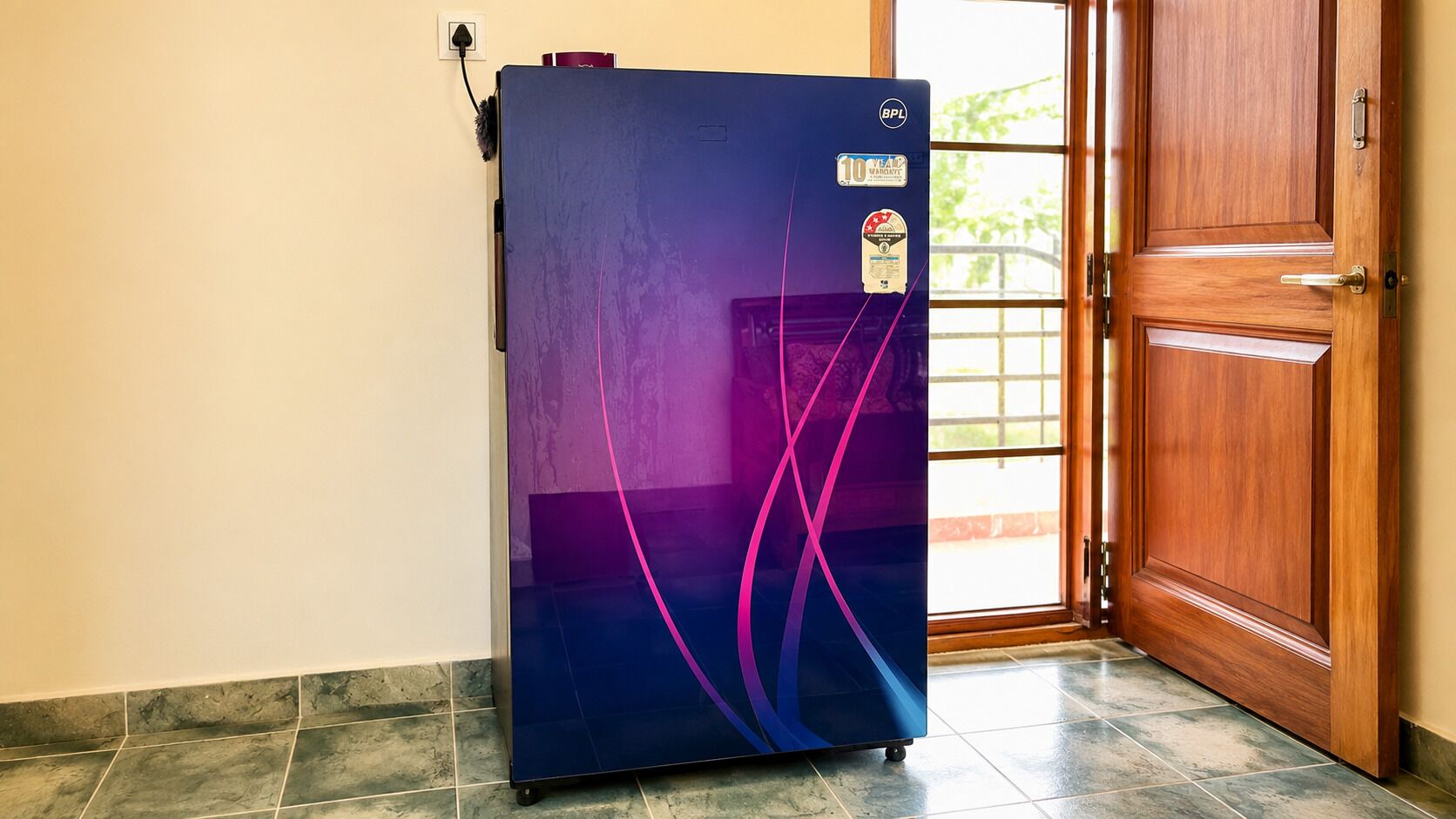 A refrigerator with a warranty sticker, a power cord, and a door with a handle.