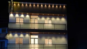 A multi-story hotel with a reception area and a visible staircase. - Saba's Courtyard (Colachel)