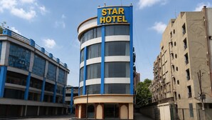 A Star Hotel building with a blue and white facade, large windows, and a prominent sign. - STAR HOTEL (Ahmedabad)