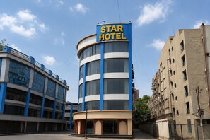 A Star Hotel building with a blue and white facade, large windows, and a prominent sign.