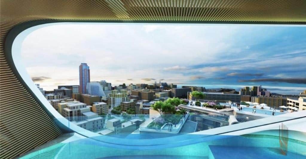 A modern building with a curved glass facade, a rooftop garden, and a view of a cityscape.