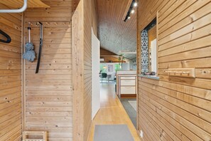A wooden interior with a hallway leading to a kitchen area. - Holiday home in Horne with sea view (Faaborg)