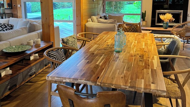A spacious living area with a large wooden dining table, comfortable seating, and a fireplace. - Family House Doussard (Lake Annecy) with swimming pool (Doussard)