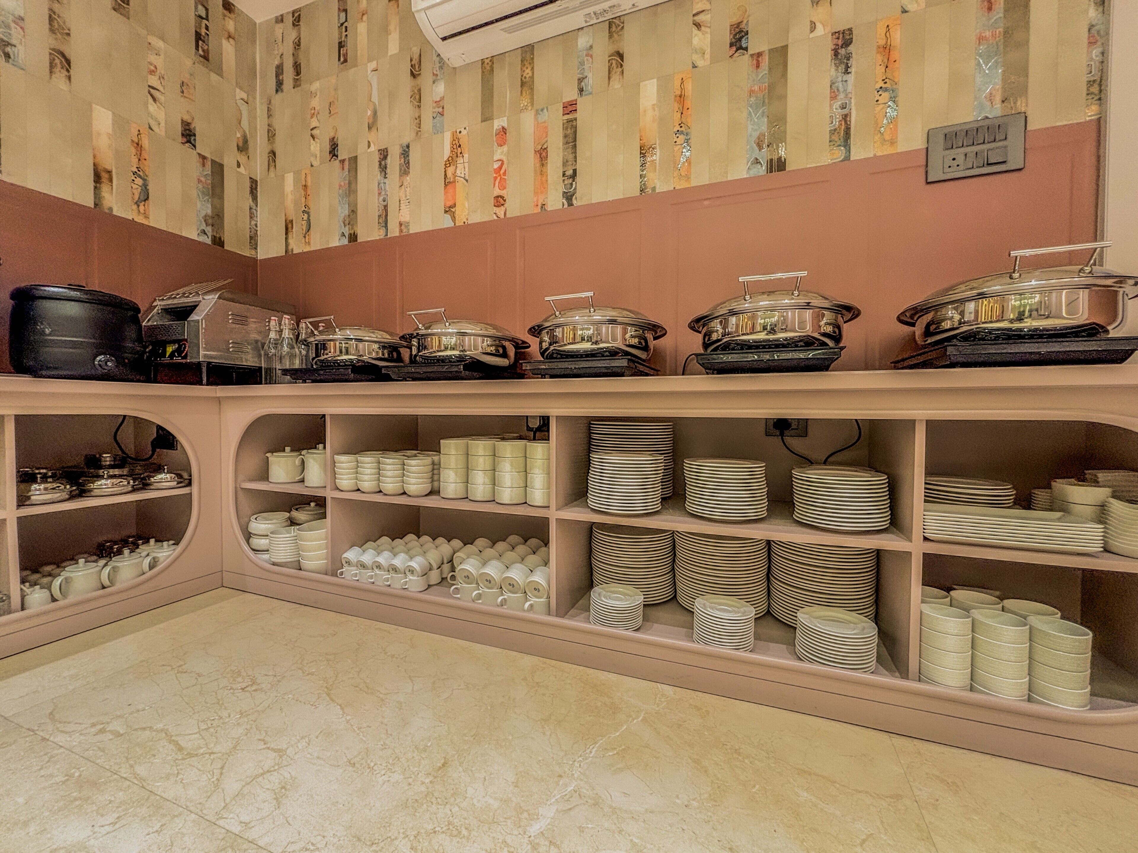 A buffet setup with various dishes and serving ware.