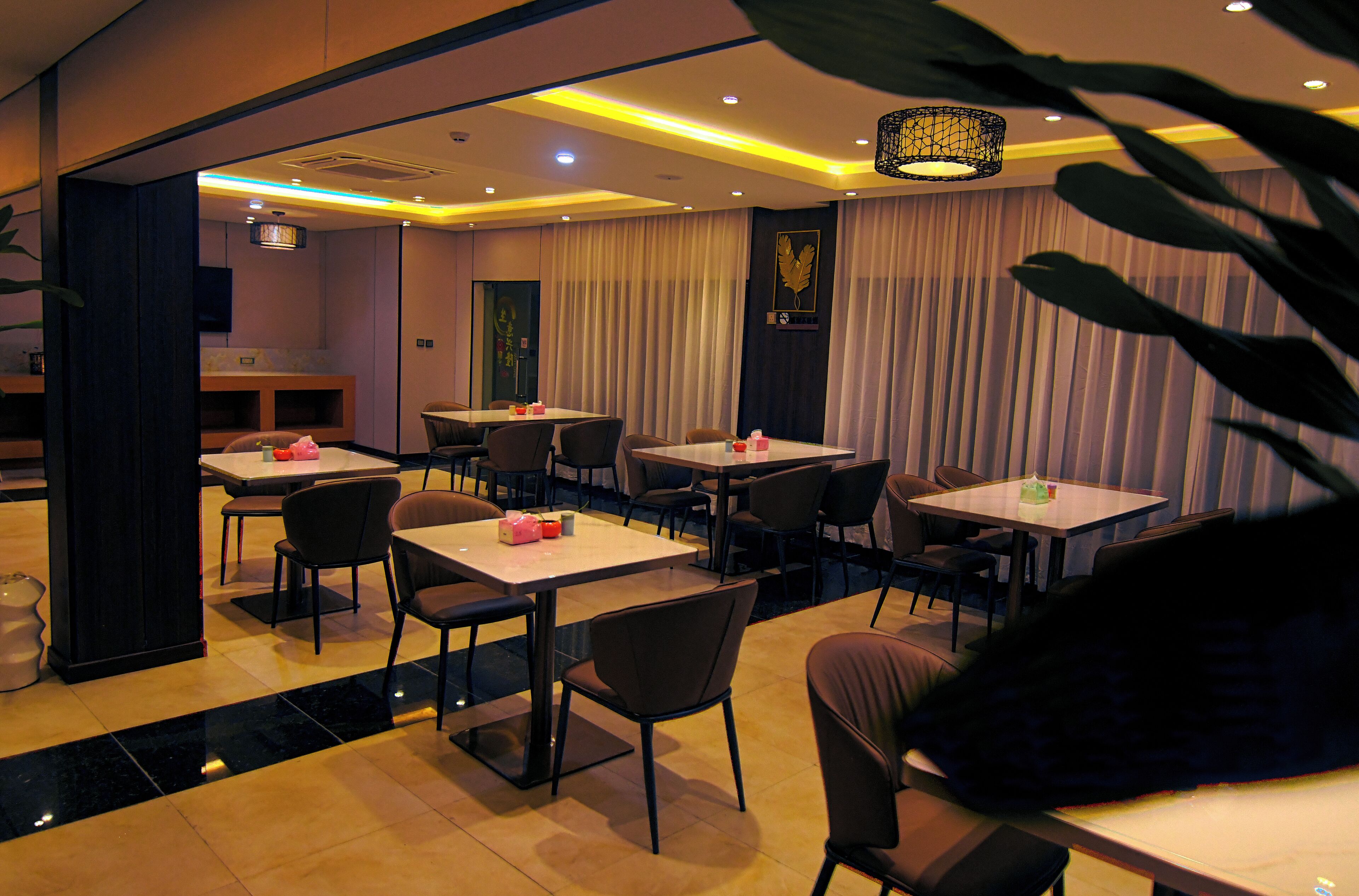 A restaurant with tables and chairs arranged for dining.