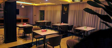 A restaurant with tables and chairs arranged for dining.