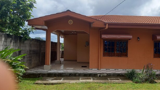 A two-story house with a tiled roof, a covered porch, and a satellite dish. - Studio for 2 persons (Ebolowa, Région du Sud)