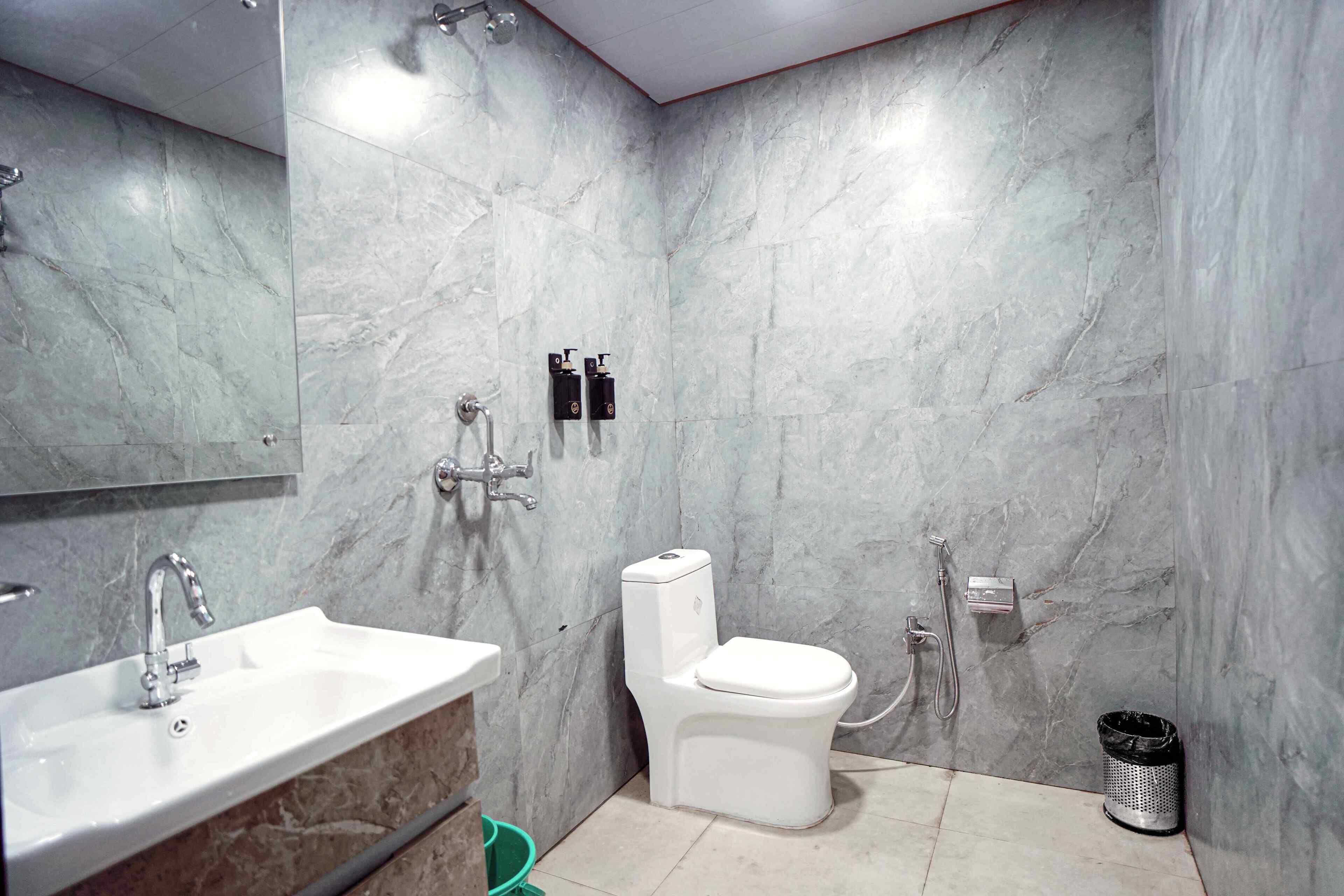 A bathroom with a sink, toilet, and shower.