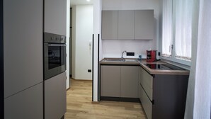 Een moderne keuken met inbouwapparatuur, een spoelbak en kasten.