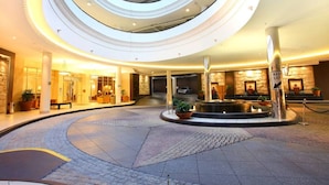 A modern hotel atrium with a circular design, multiple floors, and a central fountain. - Chevron Tower3 has 2bedrooms 2beds With Car Park (Gold Coast)