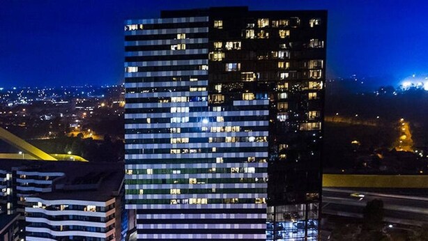 A high-rise building with multiple floors, large windows, and a modern architectural design. - Amazing City Views on 18th Floor With car Park (Melbourne)