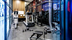 A gym with cardio machines, weightlifting equipment, and a bench. - Amazing City Views on 18th Floor With car Park (Melbourne)