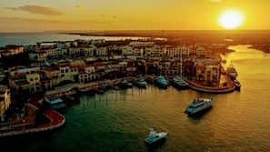 A coastal town with a marina, boats, and buildings. - Private Rooftop Penthouse Marina Resort (Punta Cana)
