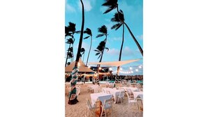 A beachside restaurant with outdoor seating, palm trees, and string lights. - Pool View, Walk to Beach, Shops, Dining, Fast Wifi (Punta Cana)