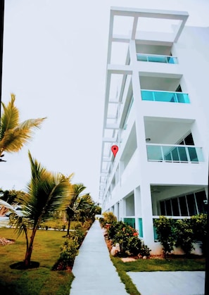 A multi-story building with a clear pathway leading to the entrance.